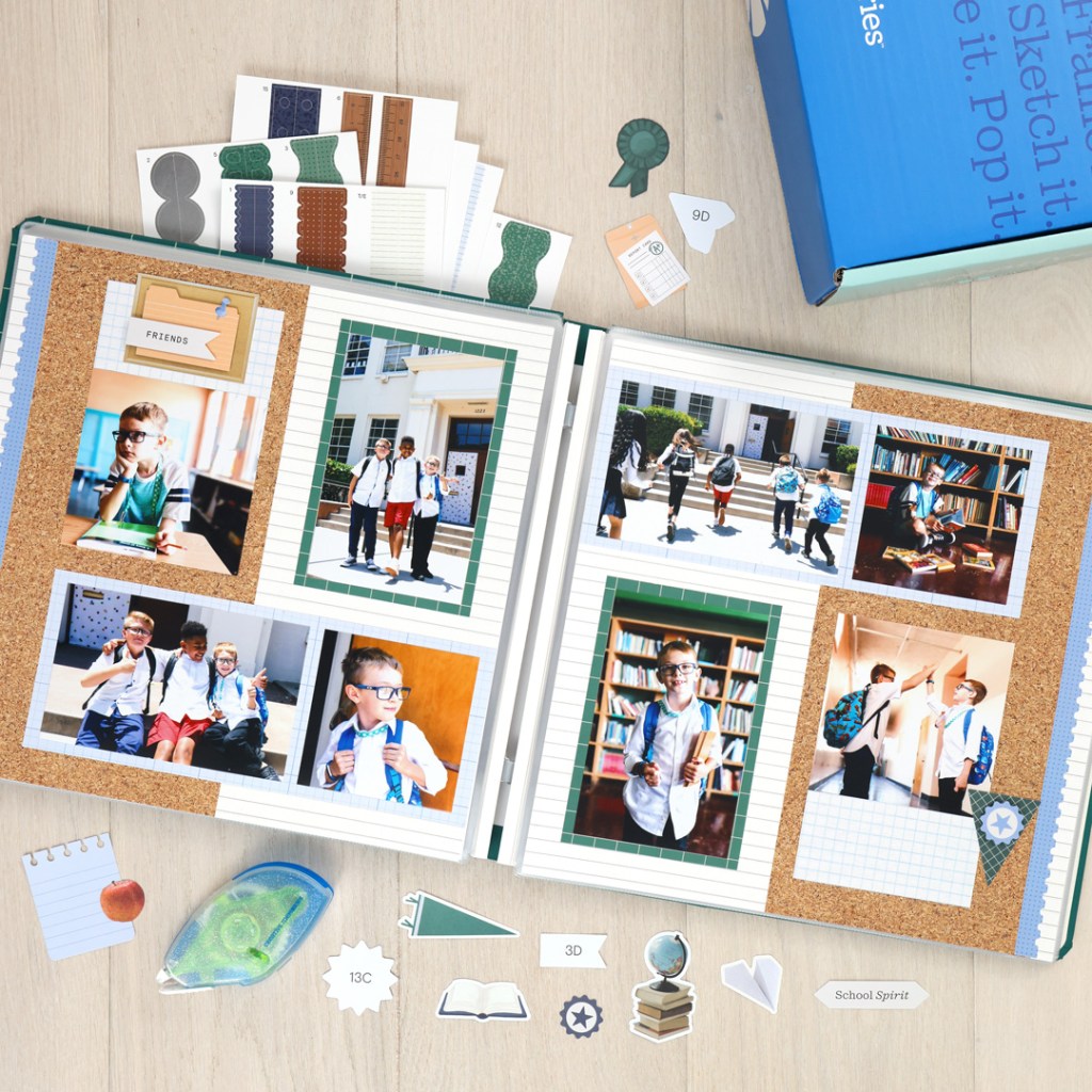 A scrapbook opened to display various photos of children engaging in school activities, surrounded by decorative items like stickers and school-themed embellishments.